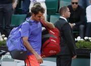 Roger Federer of Switzerland leaves the court after being defeated by his compatriot Stan Wawrinka during their men's quarter-final match during the French Open tennis tournament at the Roland Garros stadium in Paris, France, June 2, 2015. REUTERS/Vincent Kessler