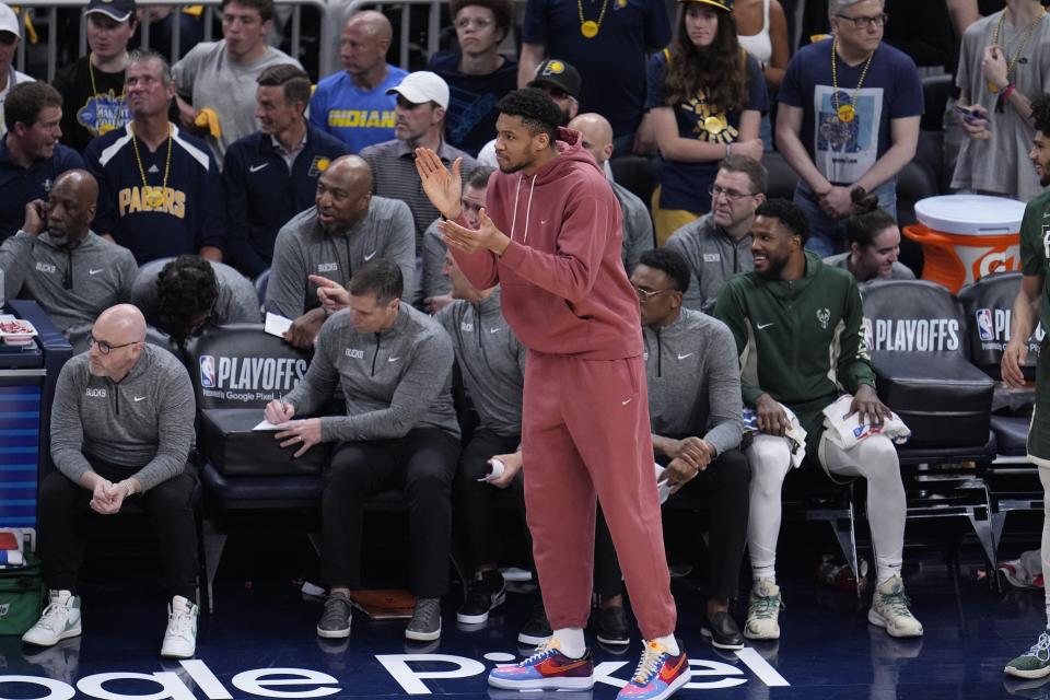 Milwaukee Bucks' Giannis Antetokounmpo cheers on his teammates during the first half of Game 4 of the first round NBA playoff basketball series against the Indiana Pacers, Sunday, April 28, 2024, in Indianapolis. (AP Photo/Michael Conroy)