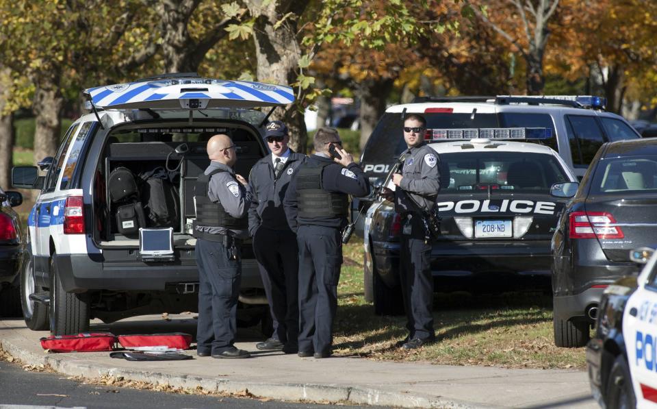 Law enforcement officers block access to Central Connecticut State University while it is in lockdown in New Britain, Connecticut November 4, 2013. A person has been taken into custody at Central Connecticut State University on Monday after officials locked down the campus when a suspicious person, possibly armed, was spotted, said New Britain Mayor Tim O'Brien. Citing students, local media said police had searched for a person who appeared to be carrying a gun and what looked like a sword. (REUTERS/Michelle McLoughlin)