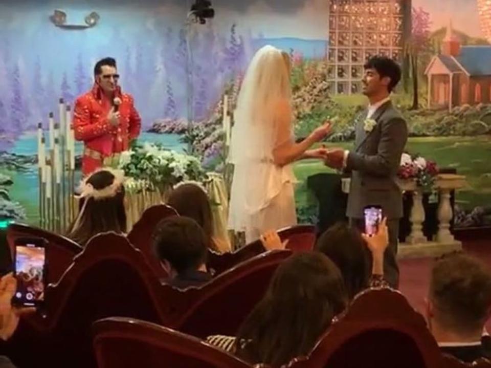 An Elvis Presley impersonator officiates as Sophie Turner and Joe Jonas place wedding rings on each other's fingers (Instagram/Diplo)
