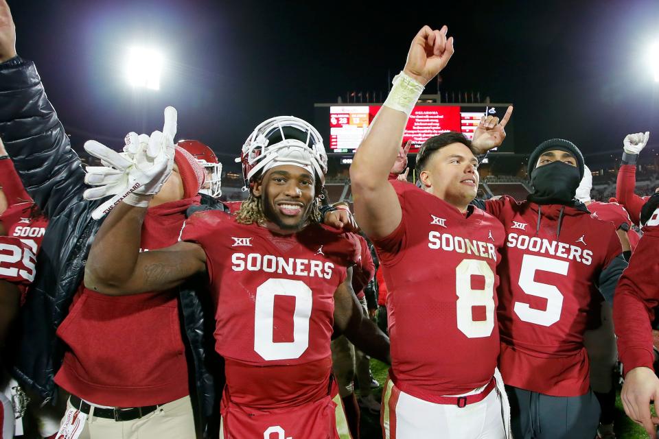 Oklahoma running back Eric Gray (0) and quarterback Dillon Gabriel (8) celebrate after the Sooners' 28-13 victory last week against Oklahoma State. Gray is the Big 12's second-leading rusher with 1,203 yards, and Gabriel is the conference's fourth-leading passer with 2,476 yards.