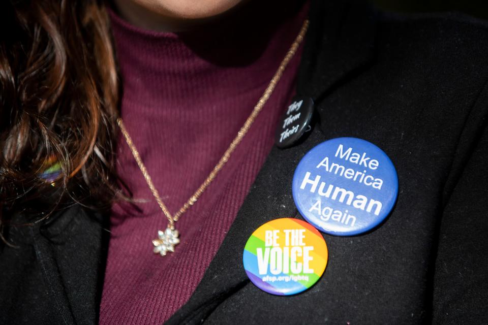 Kal Reasons, cofounder of West Tennessee LGBTQ+ Support LLC, poses for a portrait while wearing a Pride-themed button among others outside of the Madison County Courthouse on Monday, November 14, 2022, in Jackson, Tenn. 