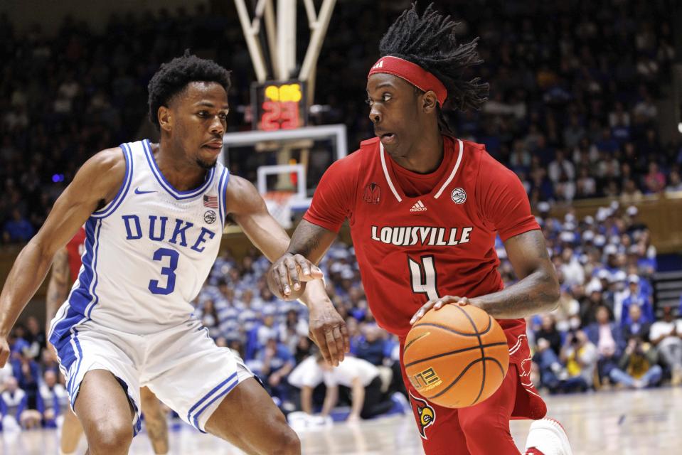 Louisville's Ty-Laur Johnson (4) drives against Duke's Jeremy Roach (3) during the first half of an NCAA college basketball game in Durham, N.C., Wednesday, Feb. 28, 2024. (AP Photo/Ben McKeown)