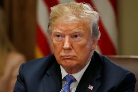 U.S. President Donald Trump listens during a cabinet meeting at the White House in Washington, U.S., July 18, 2018. REUTERS/Leah Millis