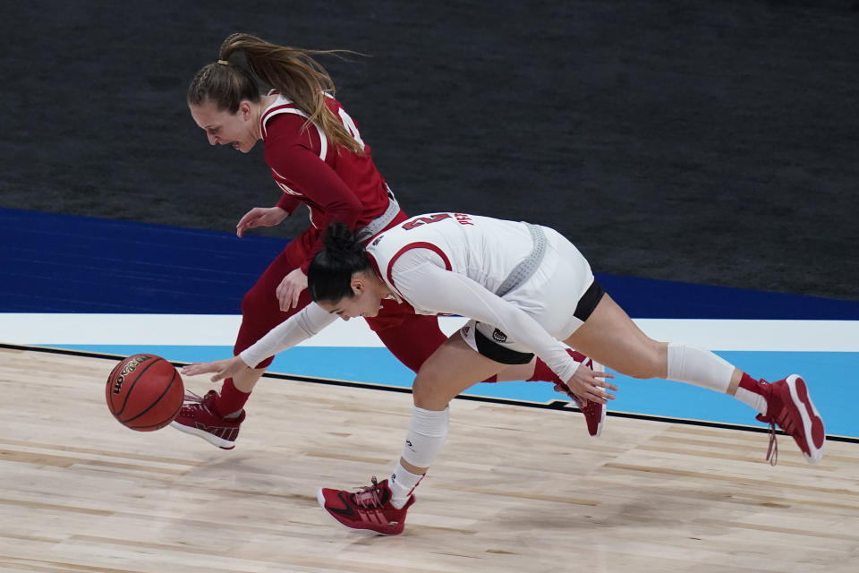 Indiana guard Nicole Cardano-Hillary, left, and North Carolina State guard Raina Perez, right, chases a loose ball during the first half of a college basketball game in the Sweet Sixteen round of the women's NCAA tournament at the Alamodome in San Antonio, Saturday, March 27, 2021. (AP Photo/Eric Gay)