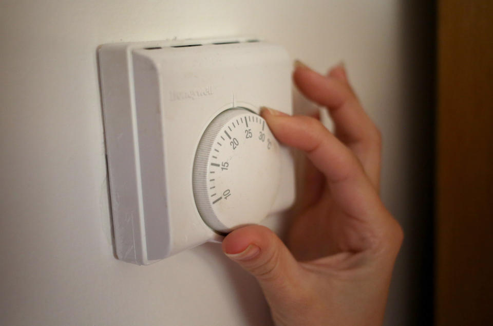 Cost of living EMBARGOED TO 0001 WEDNESDAY JANUARY 26 Undated file photo of a person using a central heating thermostat, as a report has suggested deploying heat pumps and boosting energy efficiency should be the priority for home heating in the next decade, rather than hydrogen.