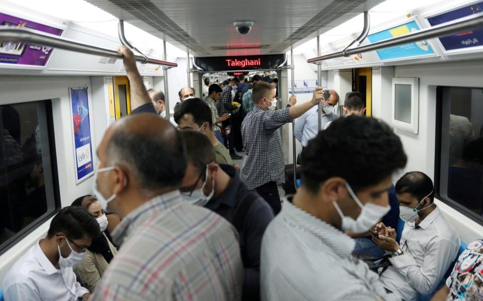 Iranians wearing protective face masks ride the metro, following the outbreak of the coronavirus disease (COVID-19), in Tehran, Iran - Reuters