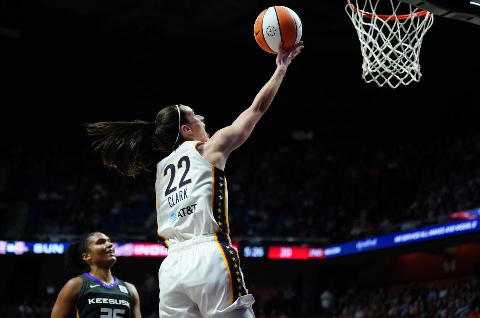 Indiana Fever guard Caitlin Clark (22) scores her first regular season basket against the Connecticut Sun on May 14, 2024.