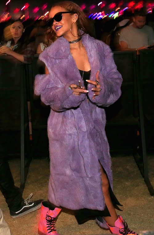 Adding yet another jacket to her ever-expanding closet filled with technicolor dreamcoats, Rihanna kept warm when the sun went down in a purple fuzzy topper, hot pink boots, and sunglasses at night.