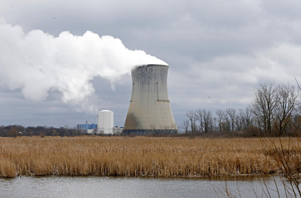 FILE – In this Tuesday, April 4, 2017, file photo, plumes of steam drift from the cooling tower of FirstEnergy Corp.'s Davis-Besse Nuclear Power Station in Oak Harbor, Ohio. A federal court docket showed that "plea agreements" were filed Thursday, Oct. 29, 2020 for defendants Jeffrey Longstreth, a longtime political adviser, and Juan Cespedes, a lobbyist described by investigators as a "key middleman" in a $60 million bribery case also involving ex-Ohio House Speaker Larry Householder alleged to have helped prop up this aging nuclear power plant and the Perry Nuclear Power Plant in North Perry, Ohio. (AP Photo/Ron Schwane, File)