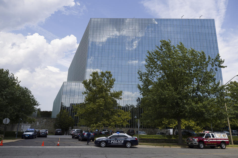 First responders are seen near the building that houses Gannett and USA Today, Wednesday, Aug. 7, 2019, in McLean, Va. (AP Photo/Alex Brandon)