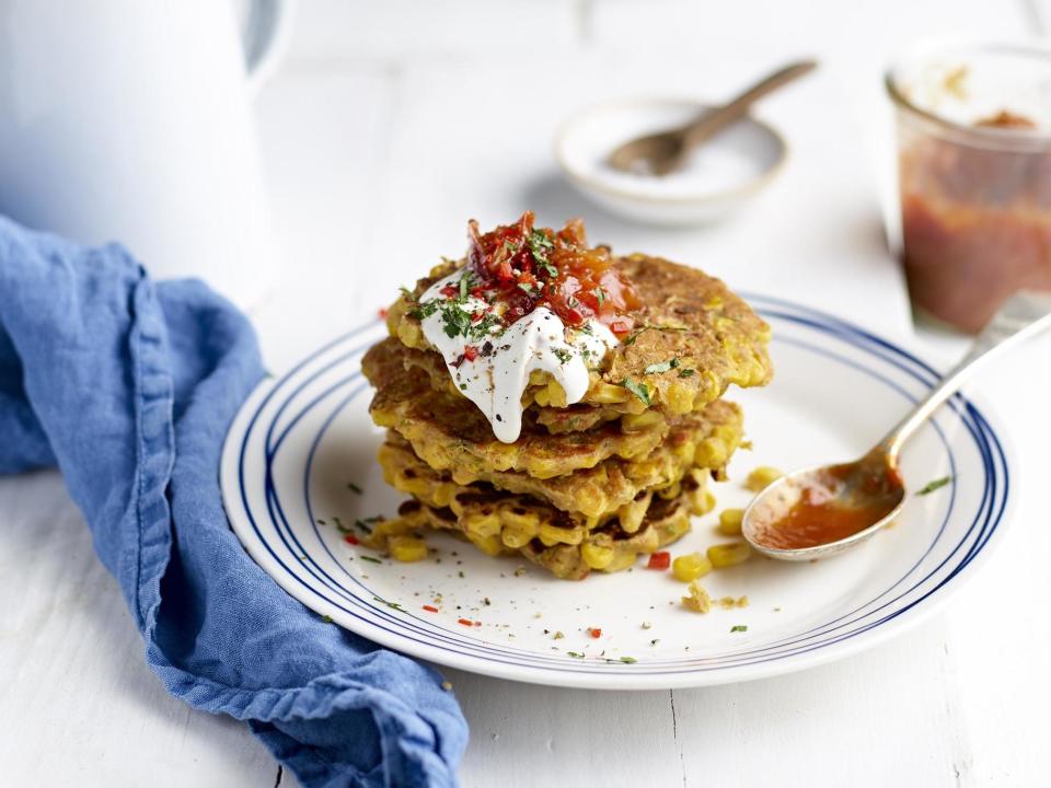 These fritters are perfect for a lazy breakfast or weekend brunch. Add a poached egg on top to really indulge.Serves 6Prep: 20 minutesCook: 10 minutesFor the chutney1 large echalion shallot, finely sliced1 tbsp sweet chilli sauce 40g golden caster sugar 85ml white wine vinegar 150g cherry tomatoes, roughly chopped For the fritters2 tbsp coconut oil1 large echalion shallot 1 clove garlic, crushed 1 small bunch coriander1 chilli, seeds removed and finely diced 2 tsp mild curry powder Sea salt and cracked black pepper 325g can sweetcorn in water 75g gram flour (chickpea flour)To serveSour cream or vegan coconut yoghurtDiced chilli Coriander, roughly choppedPlace all the chutney ingredients in a heavy-bottomed saucepan over a medium heat. Add a tablespoon of water and bring the ingredients to the boil. Lower the heat and allow to gently simmer and reduce for approximately 10-15 minutes – you want to reduce the liquid, break down the tomatoes and achieve and thick, sticky jam consistency. Remove from the heat and allow to cool and thicken further.Heat a tablespoon of coconut oil in a large pan. Gently fry the shallots in the oil for 5 minutes until softened. Add the garlic and fry for a further minute.Finely chop the stems of the coriander and add to the pan along with the chilli, curry powder and seasoning. Fry for a final minute. Spoon the shallot mixture into a large bowl and sprinkle in the gram flour and roughly chopped coriander leaves. Tip in the sweetcorn along with the liquid in the can and stir through all the ingredients. Whisking with a fork, add 50ml of cold water to create a batter. Leave to sit for 5 minutes for the gram flour to absorb some of the liquid. When the batter is ready, melt the remaining coconut oil in a clean frying pan. In batches, spoon a heaped tablespoon worth of fritter mixture into the hot pan. Turn down the heat to medium and fry for 2-3 minutes – the fritters are ready to be flipped when you can easily get a spatula underneath. Cook on the second side for a further 2 minutes. Place the cooked fritters on a lined baking tray and put in a warm oven whilst you make the remaining fritters. The mixture makes 6 decent-sized fritters.To serve, stack the fritters on a plate and top with a spoon of tomato and shallot chutney and sour cream or yoghurt. Sprinkle with a little extra chilli for heat and coriander for freshness.Recipe from ukshallot.com