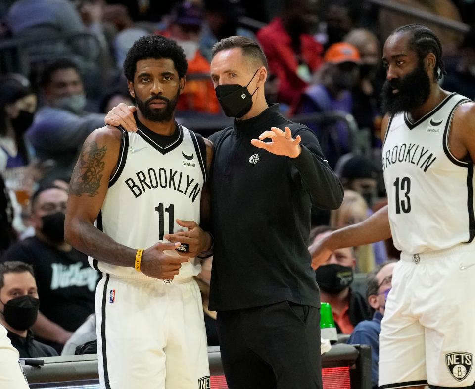 Feb 1, 2022; Phoenix, Arizona, United States;  Brooklyn Nets head coach Steve Nash talks with Brooklyn Nets guard Kyrie Irving (11) during the first quarter against the Phoenix Suns at Footprint Center. Mandatory Credit: Michael Chow-Arizona Republic