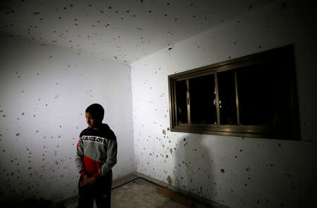 A boy looks on as he stands in a damaged house where a Palestinian gunman was killed by Israeli forces, near Nablus in the Israel-occupied West Bank December 13, 2018. REUTERS/Abed Omar Qusini