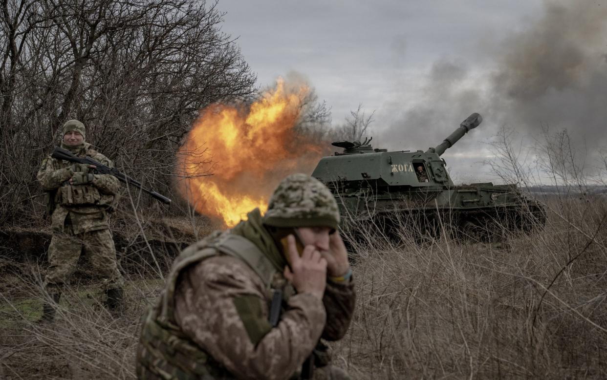 A Ukrainian soldier fires towards a Russian position