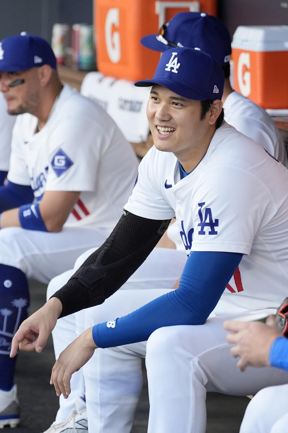 Los Angeles Dodgers' Shohei Ohtani, right, waits for the start of Game 1 of baseball's NL Division Series against the San Diego Padres, Saturday, Oct. 5, 2024, in Los Angeles. (AP Photo/Ashley Landis)