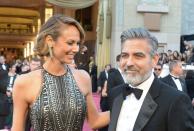 Actor George Clooney and Stacy Keibler arrive on the red carpet for the Oscars on February 24, 2013 in Hollywood, California