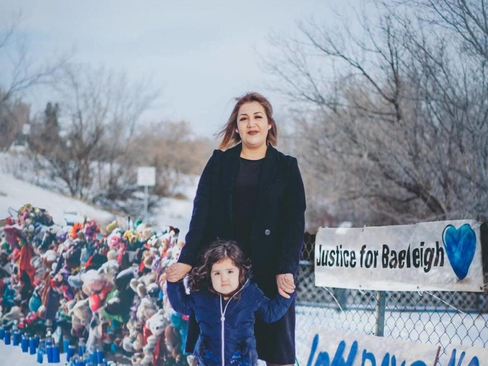 Rochelle Dubois wants justice for her daughter Baeleigh, who died after a truck driver crashed into her on Sept. 9, 2021. This photo has been digitally altered to illustrate Dubois standing with her daughter, Daenerys, in front of a memorial for Baeleigh. (All Relations Photography - image credit)
