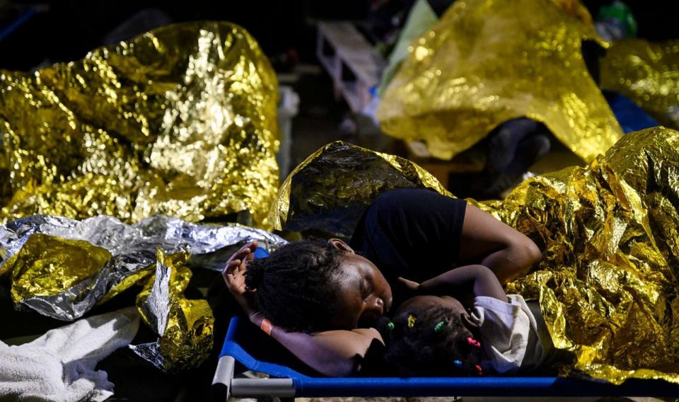 PHOTO: A woman and a child sleep outside the Lampedusa's migrant reception center in Italy, Sept. 14, 2023. (Valeria Ferraro/AP)