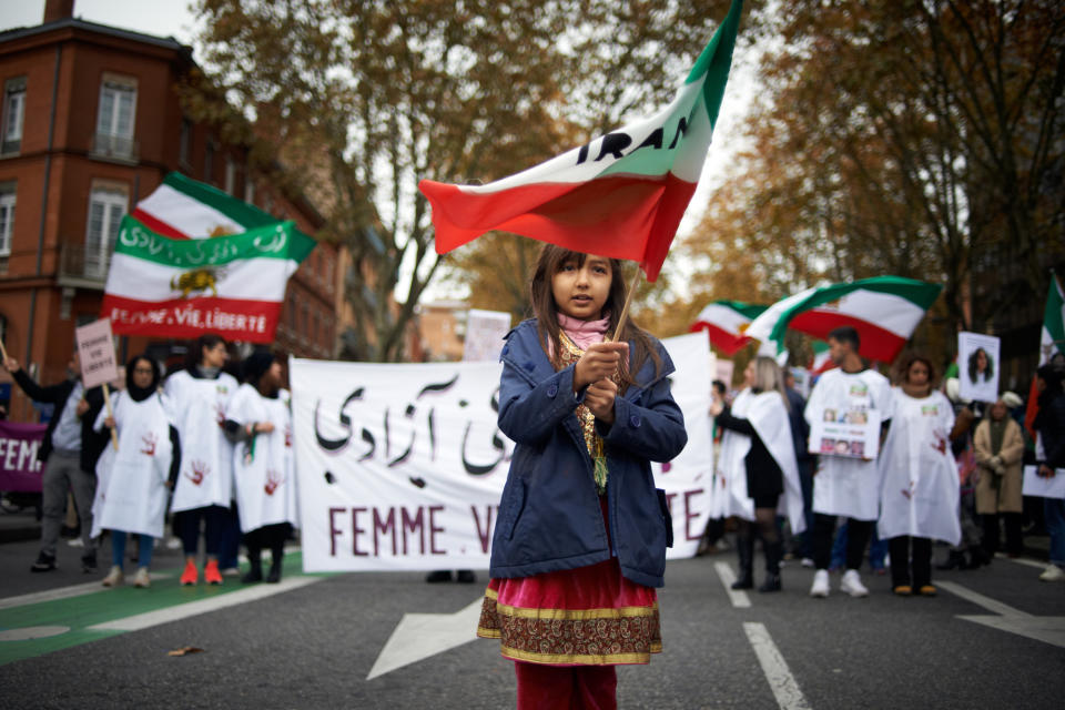 <p>A young girl waves the Iranian flag during a protest in Toulouse, France, on Dec. 3. </p>