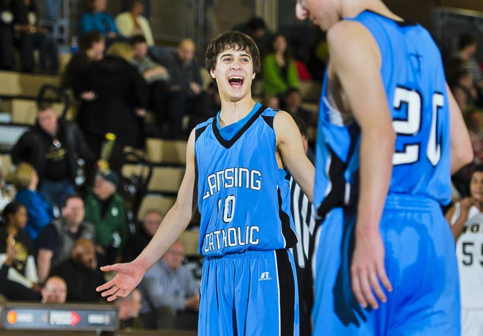 Lansing Catholic's Jacob Bullock, shown during a game against Holt on March 1, 2012 in Holt, was hired to return to his alma mater as the varsity boys basketball coach Friday.