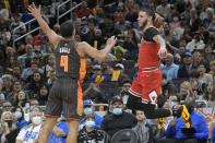 Chicago Bulls guard Lonzo Ball, right, saves a ball from going out of bounds in front of Orlando Magic guard Jalen Suggs (4) during the first half of an NBA basketball game, Friday, Nov. 26, 2021, in Orlando, Fla. (AP Photo/Phelan M. Ebenhack)