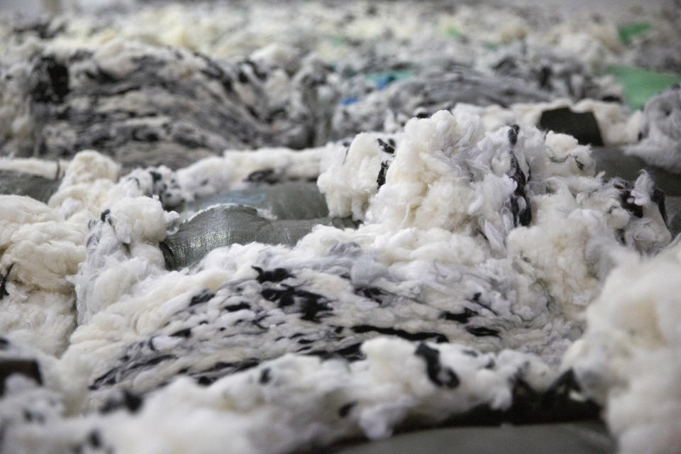 Dyed cotton is piled at a Huafu Fashion plant, as seen during a government organized trip for foreign journalists, in Aksu in western China's Xinjiang Uyghur Autonomous Region, Tuesday, April 20, 2021. A backlash against reports of forced labor and other abuses of the largely Muslim Uyghur ethnic group in Xinjiang is taking a toll on China's cotton industry, but it's unclear if the pressure will compel the government or companies to change their ways. (AP Photo/Mark Schiefelbein)