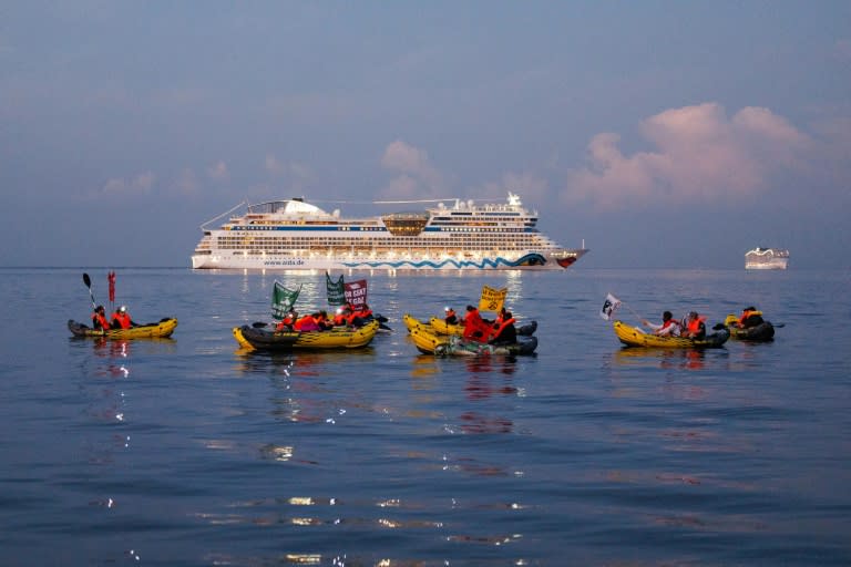 Activists from the NGO "Stop croisieres" and "Extinction Rebellion France" hold banners while they block a cruise ship (CLEMENT MAHOUDEAU)