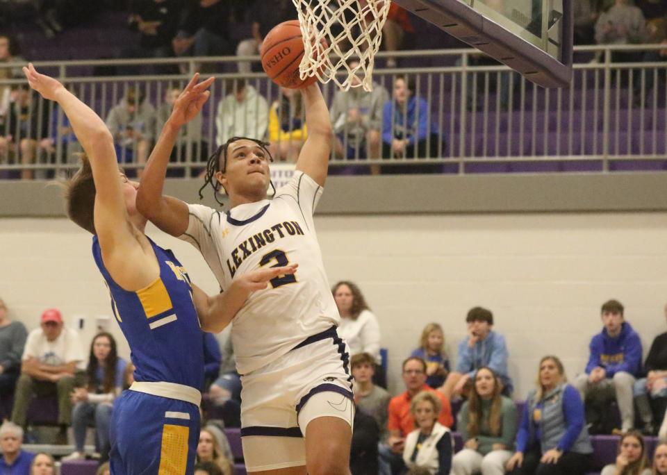 Lexington's Brayden Fogle rises up for a one-handed dunk during the Minutemen's 69-66 win over Wooster on Tuesday night in Ohio Cardinal Conference action.