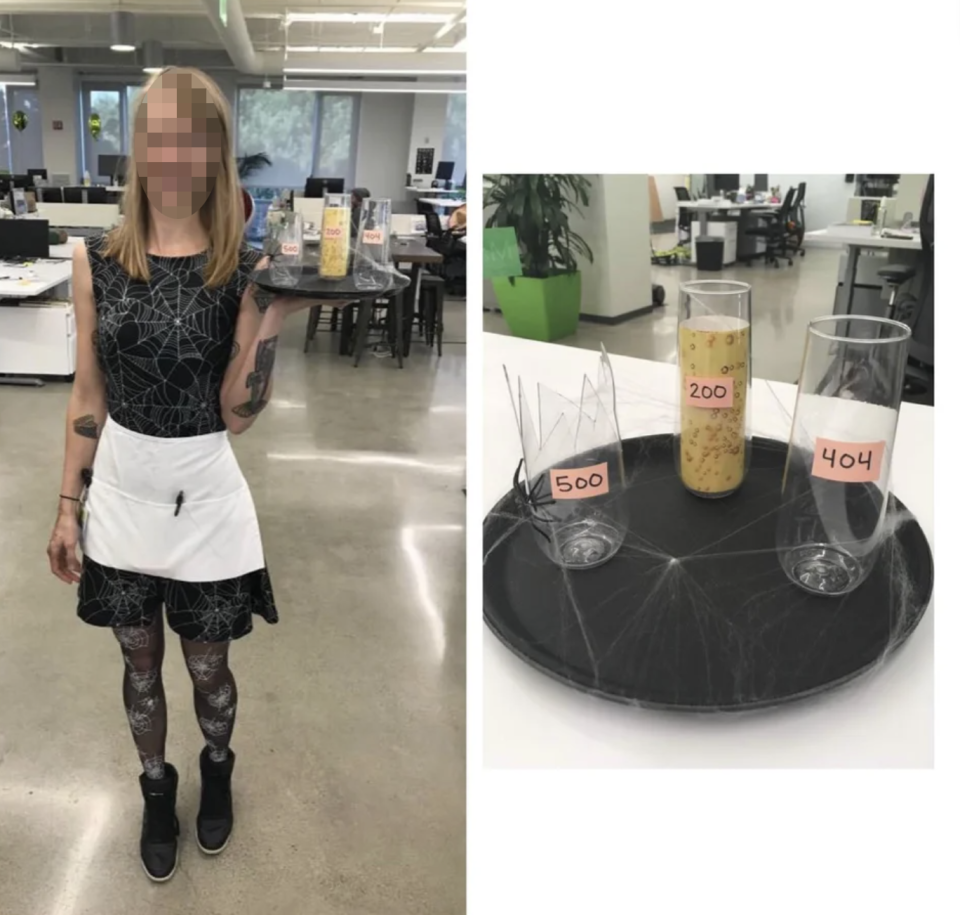 A woman dressed as a waitress in a spiderweb themed outfit with classes saying "404" "500" and "200" errors