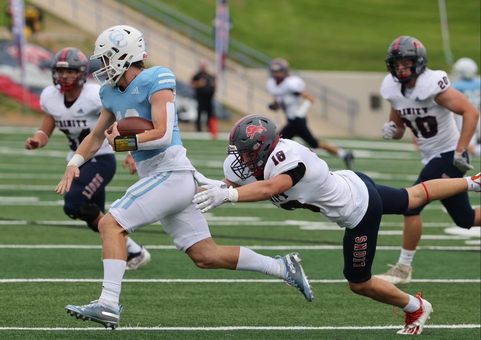 Trinity Christian's Cade Hays (18) pulls down Cypress Christian's Maxwell Landrum in the first half of a TAPPS Division II state championship game at Waco ISD Stadium in Waco, Texas.