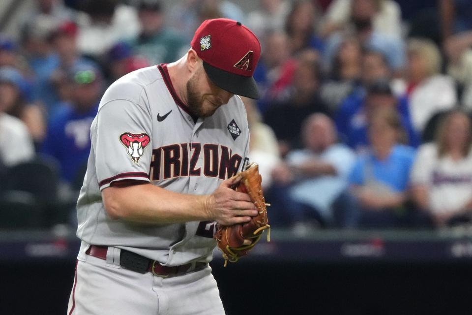 Diamondbacks starting pitcher Merrill Kelly reacts after a strikeout against the Rangers to end the seventh inning.
