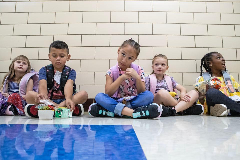 First grade students wait patiently in the hallway to enter the classroom on the first day of school at Pleasantville Elementary School near New Castle, Aug. 28, 2023.