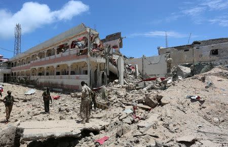 Security forces stand at the SYL hotel that was partly destroyed following a car bomb claimed by al Shabaab Islamist militants outside the president's palace in the Somali capital of Mogadishu, August 30, 2016. REUTERS/Feisal Omar