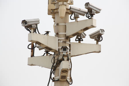 Security cameras are attached to a pole on Beijing's Tiananmen Square, China May 19, 2017. REUTERS/Thomas Peter