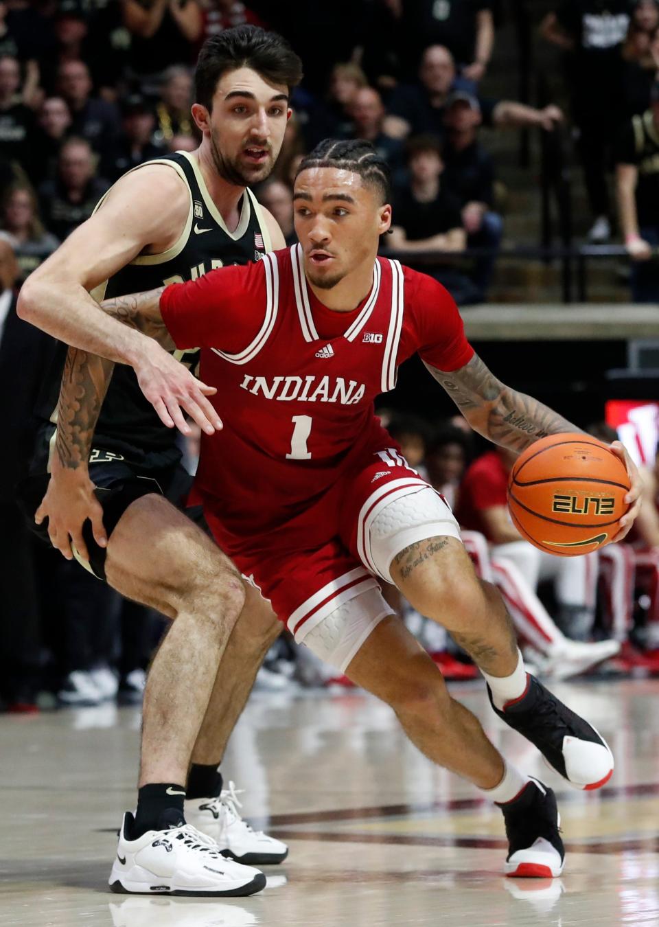 Purdue Boilermakers guard Ethan Morton (25) defends Indiana Hoosiers guard Jalen Hood-Schifino (1) during the NCAA menâ€™s basketball game, Saturday, Feb. 25, 2023, at Mackey Arena in West Lafayette, Ind.