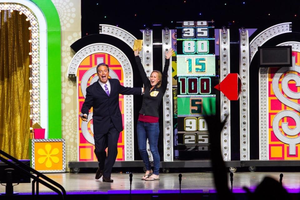 Todd Newton celebrates with a contestant on a previous performance of "The Price Is Right Live," which will be coming to Van Wezel Performing Arts Hall in Sarasota on Friday.