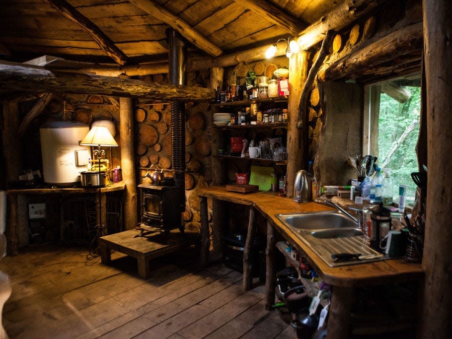 a dimly lit photo of the kitchen inside the hobbit house