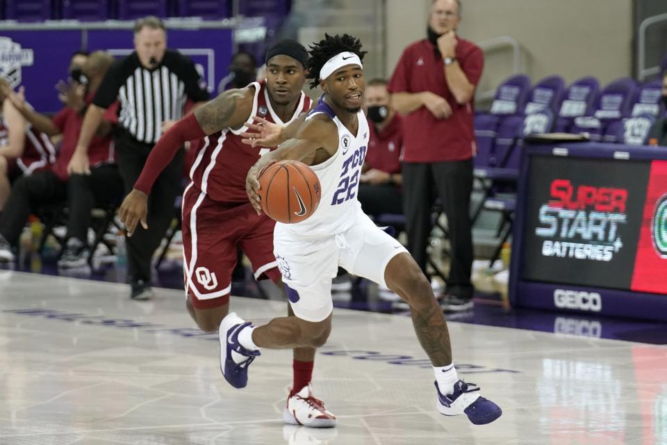 TCU guard RJ Nembhard (22) comes away with a steal as Oklahoma guard De'Vion Harmon, rear, pursues in the second half of an NCAA college basketball game in Fort Worth, Texas, Sunday, Dec. 6, 2020. (AP Photo/Tony Gutierrez)