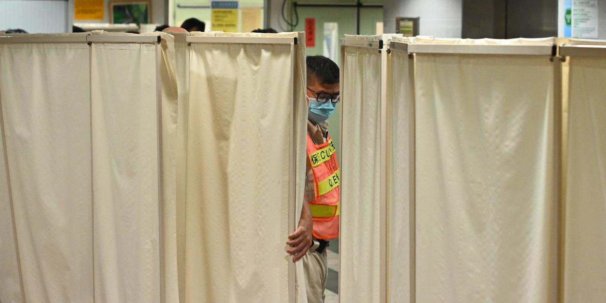 A security guard stands inside the intensive care unit of Queen Elizabeth Hospital in Hong Kong on November 8, 2019. - Alex Chow, a computer science undergraduate of the University of Science and Technology, who fell from a multi-storey car park while police and protesters were clashing last weekend has died, hospital officials said on November 8, 2019, in a development likely to raise tensions after months of violent protests in the city. (Photo by Philip FONG / AFP) (Photo by PHILIP FONG/AFP via Getty Images)