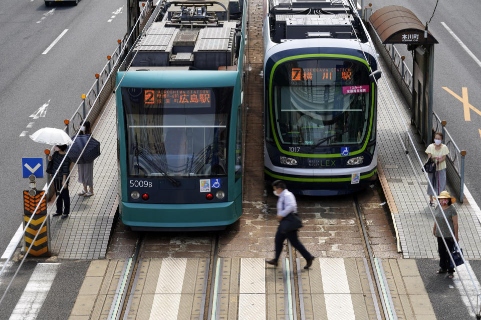 Trams are seen on a street in Hiroshima, western Japan, Monday, Aug. 3, 2020. A tram which survived the Hiroshima atomic bombing will run, without any passenger, on the streets on Aug. 6 to commemorate the day of atomic bombing in the city. (AP Photo/Eugene Hoshiko)