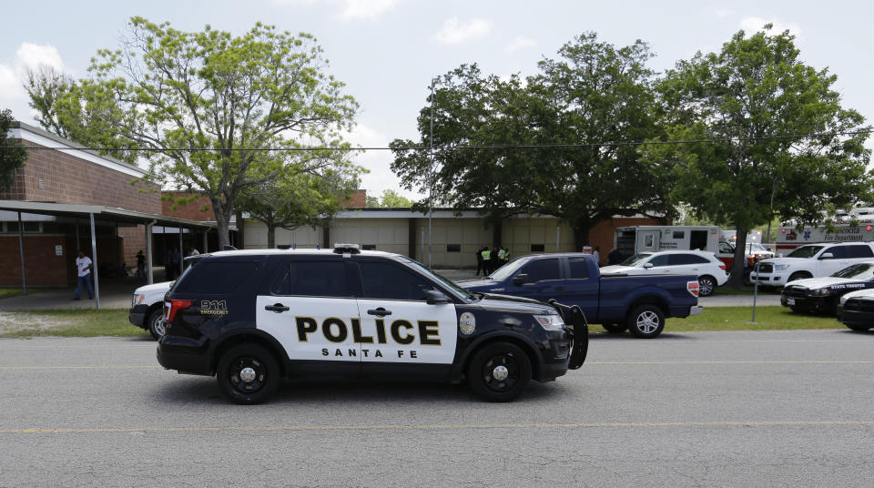 <p>Police cars are parked outside the Alamo Gym where students and parents wait to reunite following a shooting at Santa Fe High School Friday, May 18, 2018, in Santa Fe, Texas. (Photo: David J. Phillip/AP) </p>