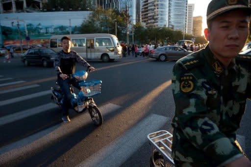 People cross a traffic intersection in Beijing. Problems in the broader global economy, including Europe's prolonged debt crisis and a sluggish recovery in the US -- both major trading partners for China -- have been a drag on growth