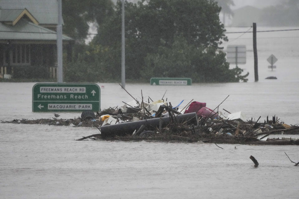 Debris sits in the middle of the flooded Windsor Bridge on the outskirts of Sydney, Australia, Monday, July 4, 2022. More than 30,000 residents of Sydney and its surrounds have been told to evacuate or prepare to abandon their homes on Monday as Australia's largest city braces for what could be its worst flooding in 18 months. (AP Photo/Mark Baker)