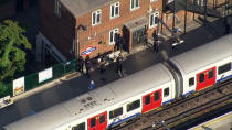 <p>In this aerial image made from video, police officers work at the Parsons Green Underground Station after an explosion in London Friday, Sept. 15, 2017. (Photo: Pool via AP) </p>