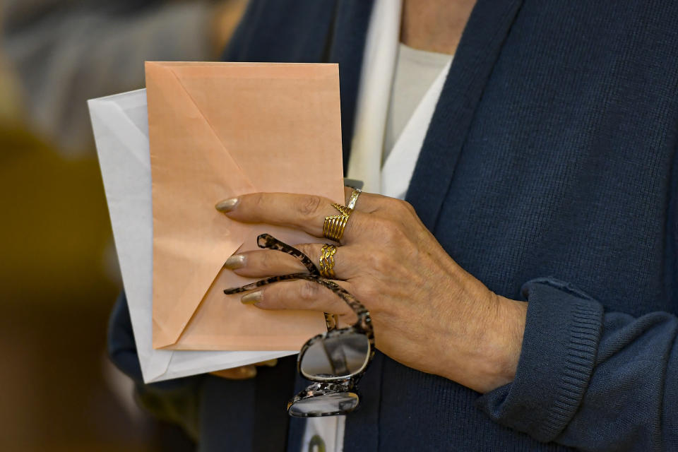 A resident waits at a polling station to casts her vote in the regional election in Pamplona, northern Spain, Sunday, May 28, 2023. (AP Photo/Alvaro Barrientos)