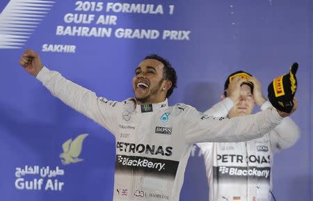 Mercedes Formula One driver Lewis Hamilton of Britain celebrates on the podium after winning the Bahrain's F1 Grand Prix at Bahrain International Circuit, south of Manama April 19, 2015. REUTERS/Hamad I Mohammed