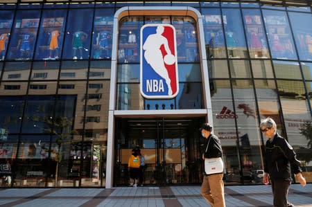 FILE PHOTO: People enter a flagship NBA store at the Wangfujing shopping street