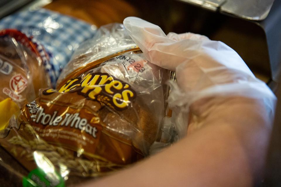 Joanie Garza, a public health inspector with the city, checks the expiration date on bread during a restaurant inspection on June, 6 2023, in Corpus Christi, Texas.