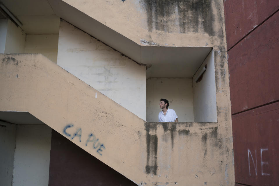 In this photo taken on Dec. 15, 2019, Vincent Achour, a psychiatry intern on strike climbs the concrete stairs leading the the intern residency at Marseille's La Timone hospital, southern France. In a hospital in Marseille, student doctors are holding an exceptional, open-ended strike to demand a better future. France’s vaunted public hospital system is increasingly stretched to its limits after years of cost cuts, and the interns at La Timone - one of the country’s biggest hospitals - say their internships are failing to prepare them as medical professionals. Instead, the doctors-in-training are being used to fill the gaps. (AP Photo/Daniel Cole)